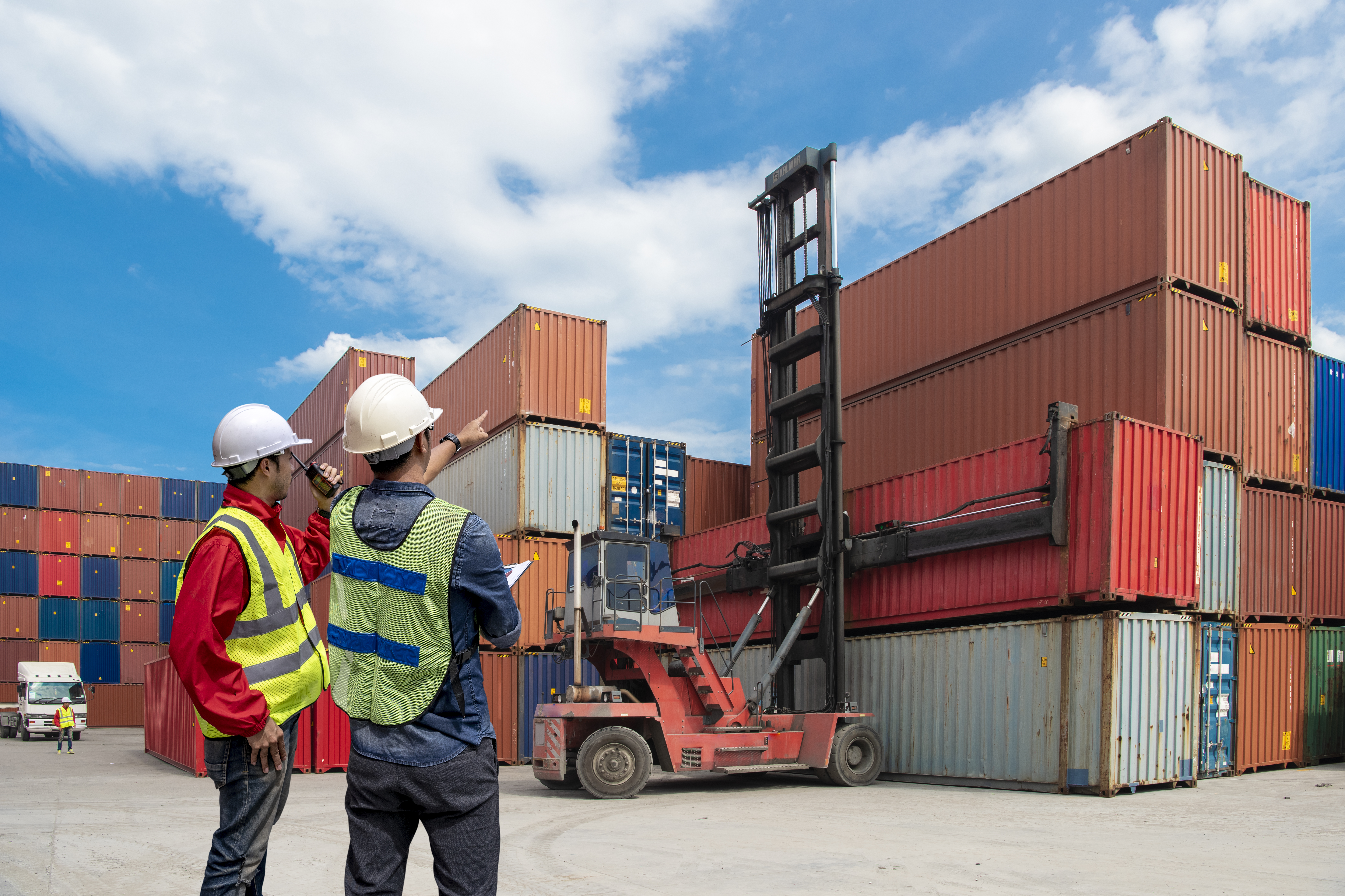 Foreman control loading Containers box to truck for Logistic Import Export Background, Business logistic concept, import and export concept.